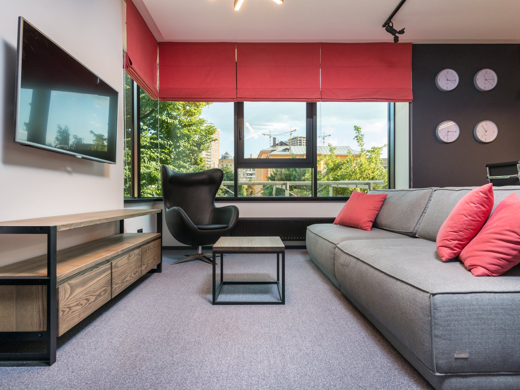 modern office interior with sofa against television and tables